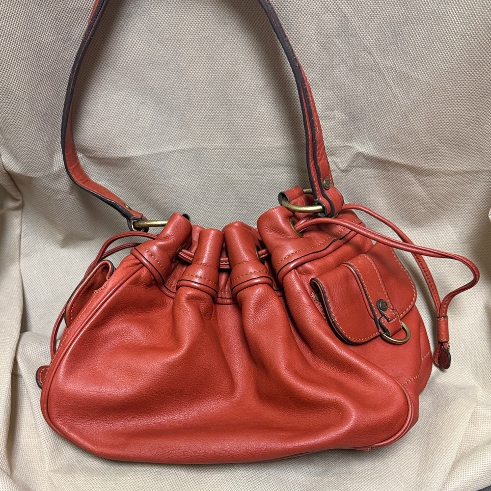 Ellen Tracy red leather drawstring bucket bag.
